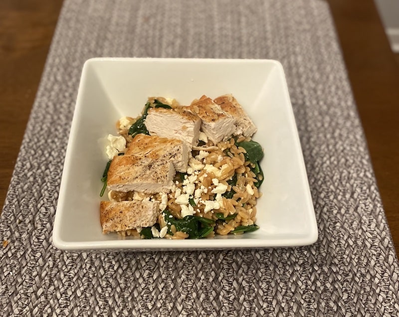 bowl of chicken orzo with feta and spinach
